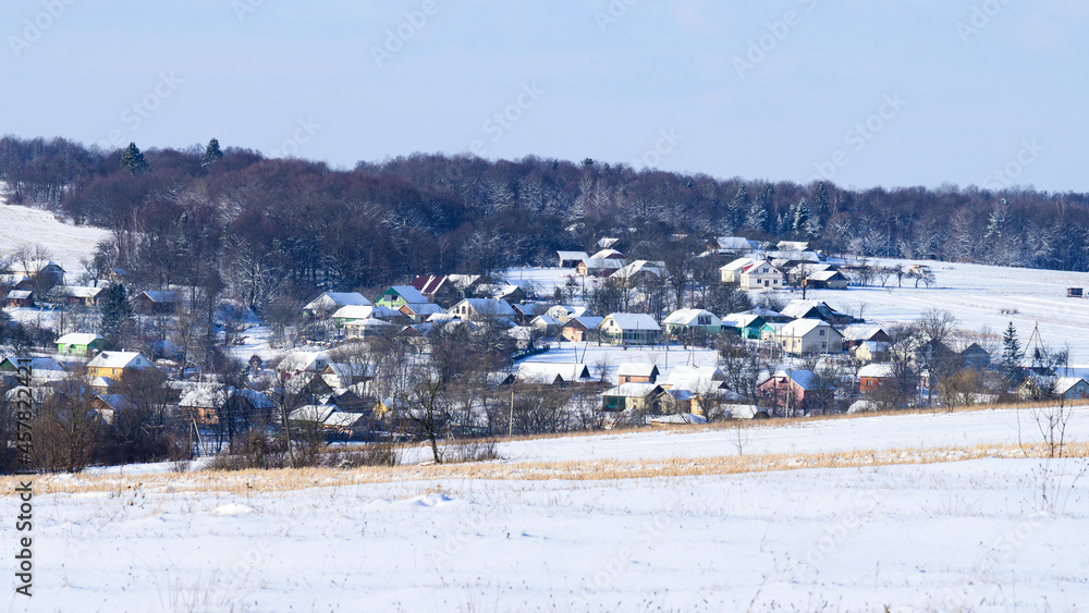 Ukrainian snow-covered villages, panorama of winter and evening villages.