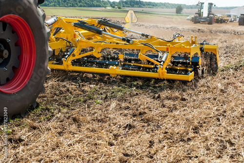 cultivator at work, close up of a disc harrow on a field background