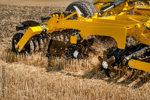 cultivator at work, close up of a disc harrow on a field background