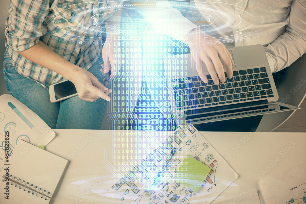 Double exposure of man and woman working together and data theme hologram drawing. Computer background. Top View. Double exposure of man and woman working together and data theme hologram drawing. Computer background. Top View.