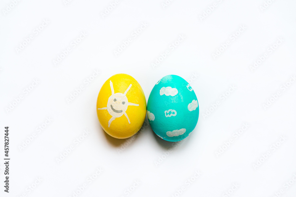 A set of colored Easter eggs painted like smiling sun and blue sky.