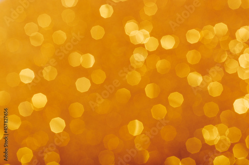 Golden glowing sparkles blurred background