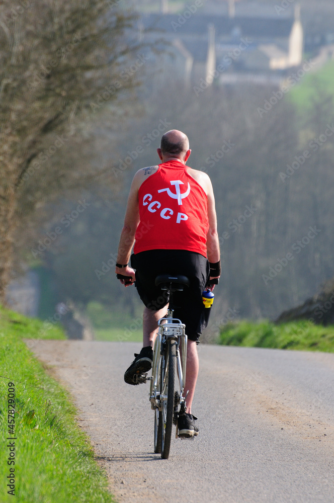 Fototapeta premium Man cycling wearing a T-shirt with the symbol of CCCP