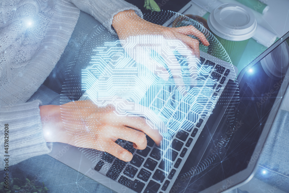 Double exposure of woman hands working on computer and brain hologram drawing. Ai concept.