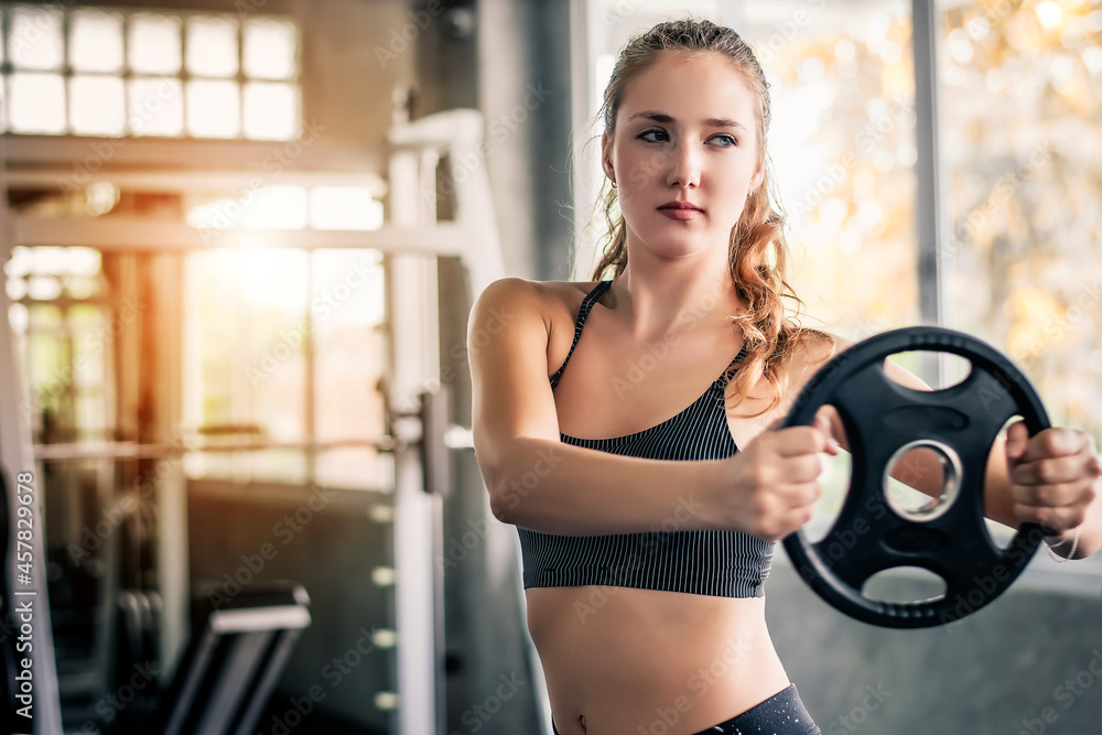 Warm tone of young attractive fitness sensual woman exercise with machine in gym. Individual sport to fit muscles of body for healthy life concept.
Warm tone of young attractive fitness sensual woman exercise with machine in gym. Individual sport to fit muscles of body for healthy life concept.