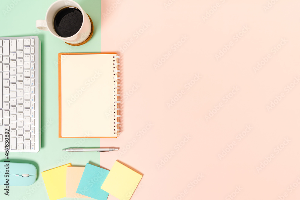Creative flat lay photo of workspace desk. Top view office desk with keyboard, mouse and open mockup black notebook on pastel green pink color background. Top view mock up with copy space photography. Creative flat lay photo of workspace desk. Top view office desk with keyboard, mouse and open mockup black notebook on pastel green pink color background. Top view mock up with copy space photography.