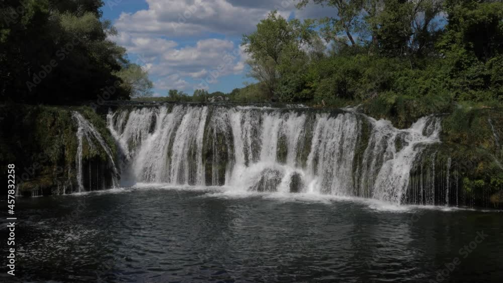 Slow motion shot of a beautiful and peaceful waterfall in the wilderness Slow motion shot of a beautiful and peaceful waterfall in the wilderness