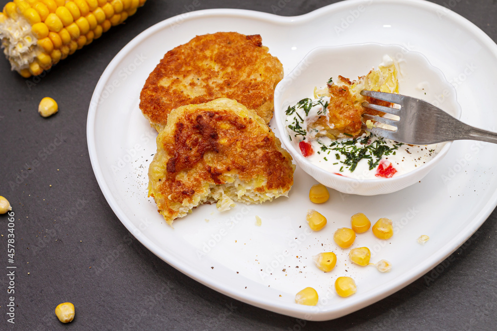 Delicious catlets on a plate with sauce of sour cream and greens close-up. Delicious catlets on a plate with sauce of sour cream and greens close-up.