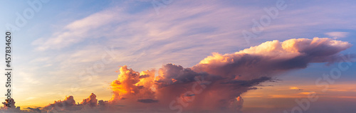 The clouds were exposed to sunlight, creating bright colors in the morning, panoramic sky scene