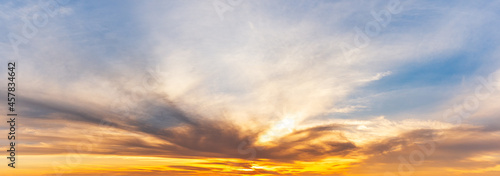 Panorama view of golden sky with sunrise and clouds, natural scenery