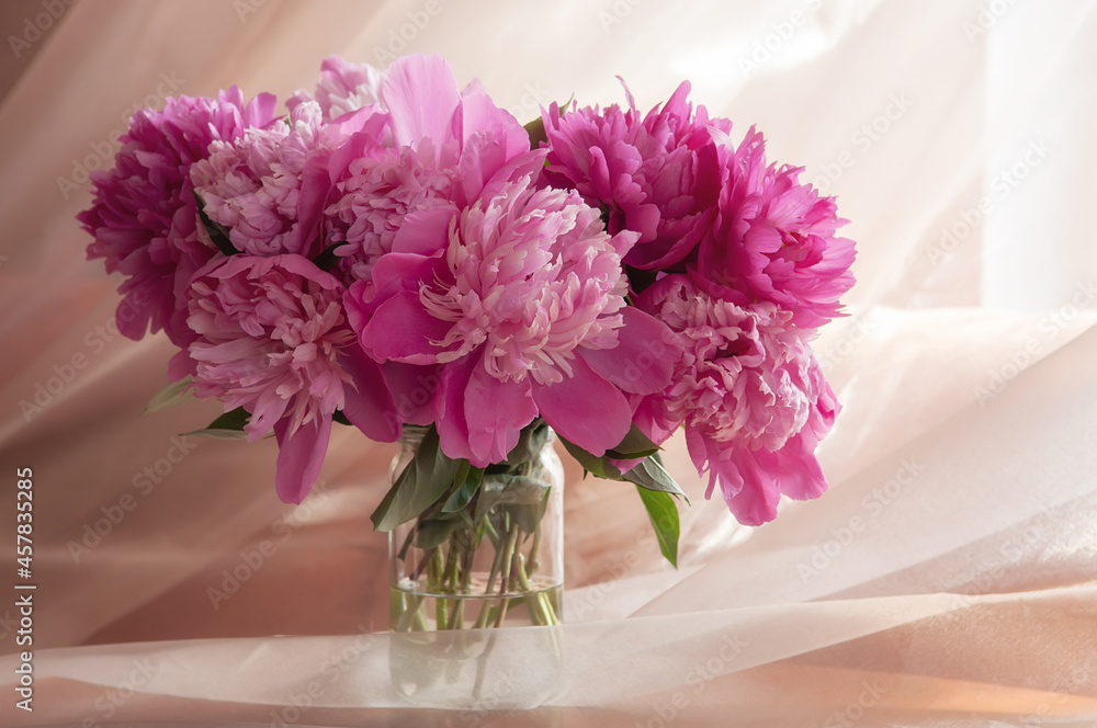 Bouquet of pink peonies in vase on a beige background Bouquet of pink peonies in vase on a beige background