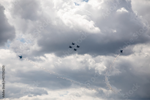Combat aircraft are flying against the background of the sky. Cloudy sky. Beautiful fighters.