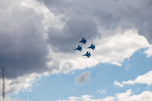 Combat aircraft are flying against the background of the sky. Cloudy sky. Beautiful fighters.