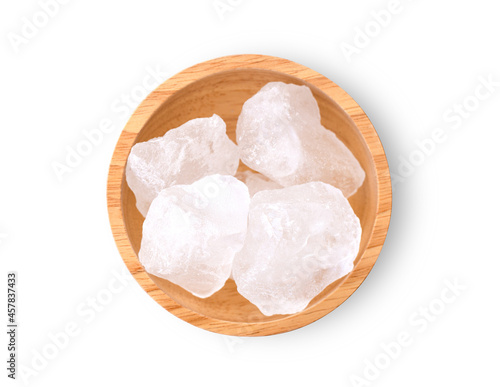Alum stone in wooden bowl isolated on white background. Top view. Flat lay. photo