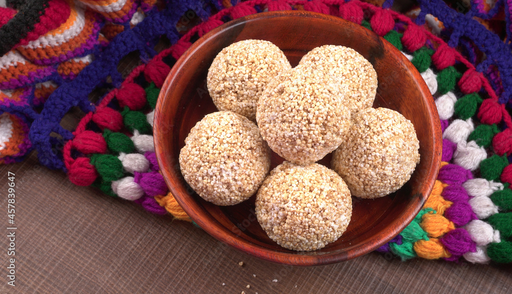 Amarnath seed, Cholai or Rajgira laddo, Also in cube shape called chikki or cake form, Indian sweet and healthy food served in a plate and bowl. Selective focus. Amarnath seed, Cholai or Rajgira laddo, Also in cube shape called chikki or cake form, Indian sweet and healthy food served in a plate and bowl. Selective focus.