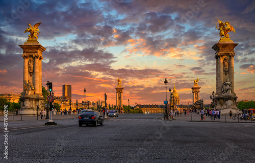 Pont Alexandre III bridge over river Seine and Hotel des Invalides on background at sunset in Paris, France.  Cityscape of Paris. Architecture and landmarks of Paris.