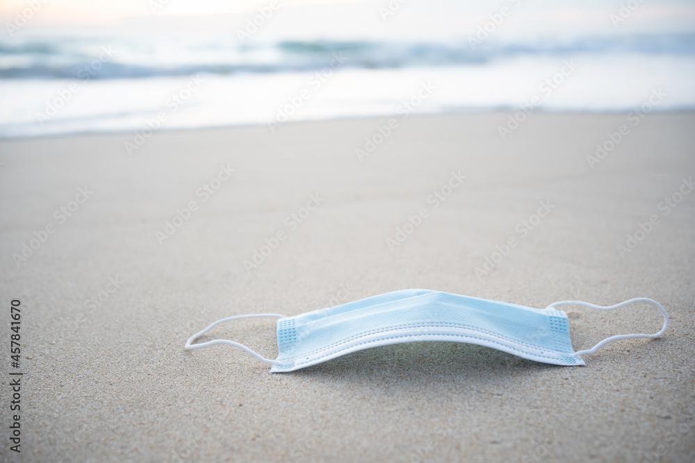 Face mask on beach during the corona pandemic.Mask and corona virus protection concept. Face mask on beach during the corona pandemic.Mask and corona virus protection concept.