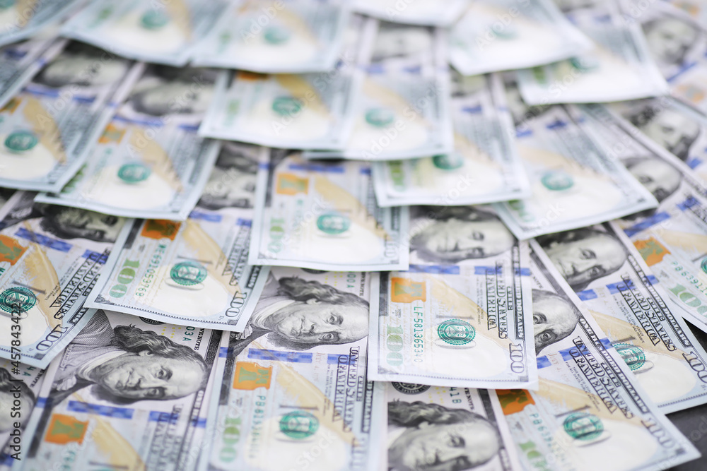 Group of money stack of 100 US dollars banknotes a lot of the background texture. Cash money in a large pile as a finance background. Group of money stack of 100 US dollars banknotes a lot of the background texture. Cash money in a large pile as a finance background.