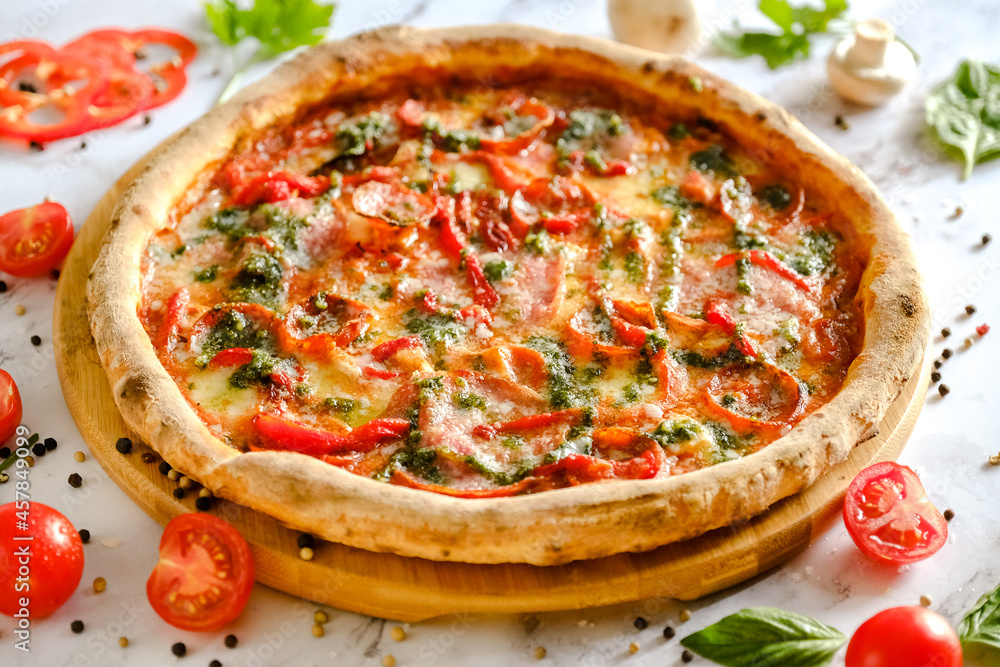 Appetizing, fresh pizza is on the table. Food from an Italian restaurant. Cooking pizza. Pizza ingredients. Appetizing, fresh pizza is on the table. Food from an Italian restaurant. Cooking pizza. Pizza ingredients.