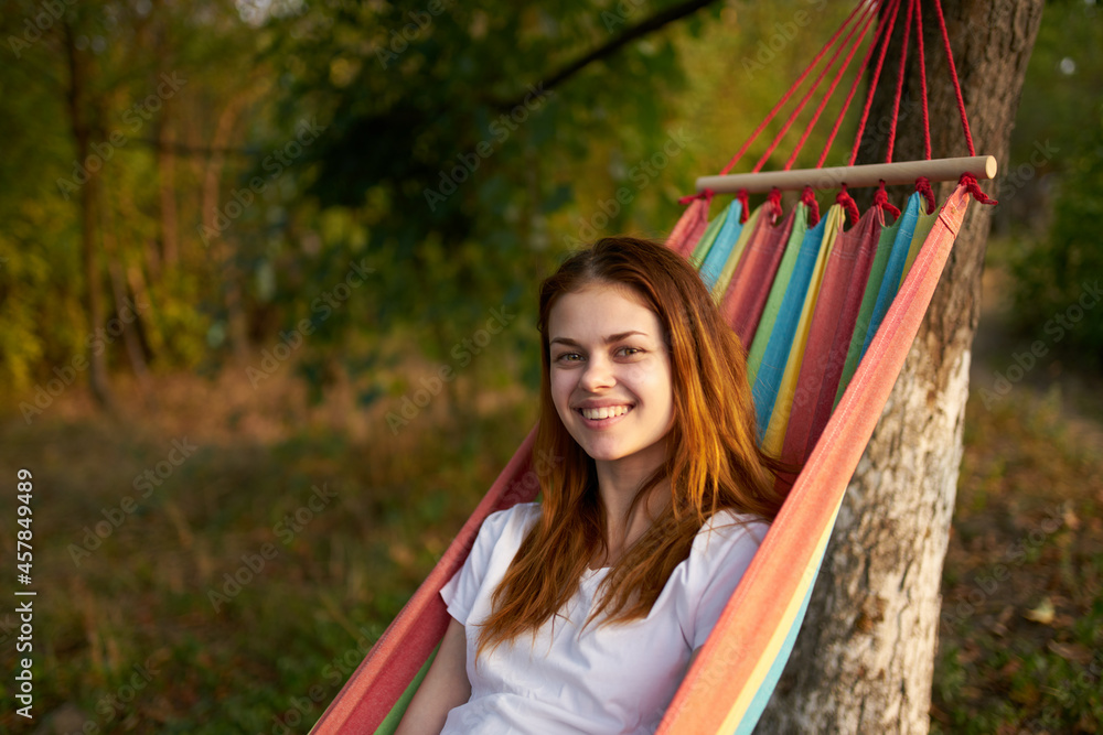 Naklejka premium joyful woman in nature lies in a hammock rest Comfort