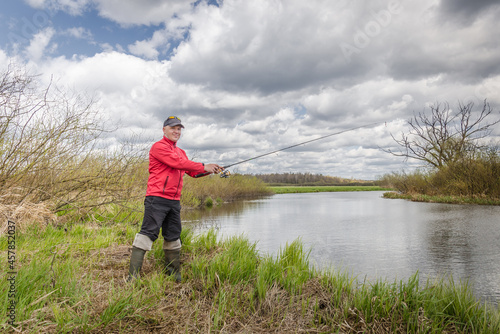 Fisherman in red clothes is fishing.