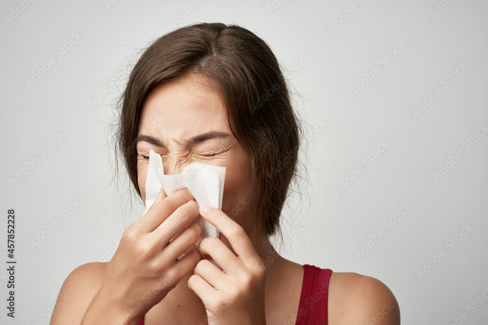 woman wipes her nose with a handkerchief health problems woman wipes her nose with a handkerchief health problems