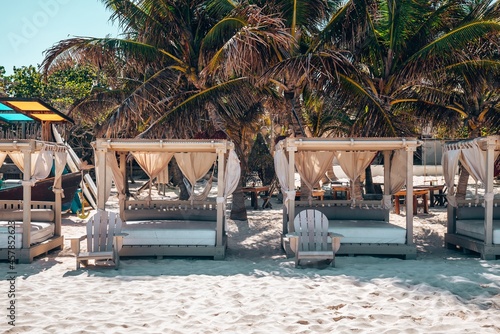 Luxury beach beds with chairs at a beautiful resort in Mexico. Empty gazebo lounge at tropical resort