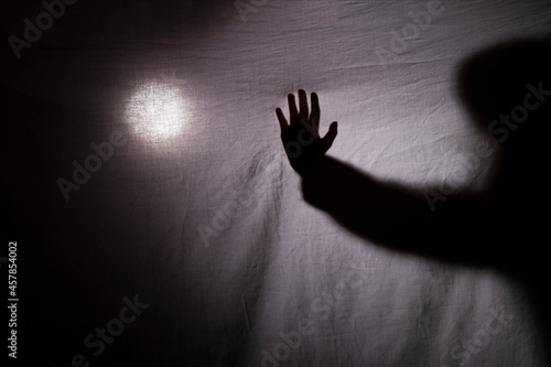 halloween. a shadow or silhouette of two hands, with a white cloth. in transparency with space to copy your text