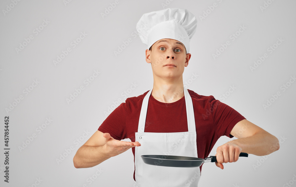 a man in a chef's uniform cooking work professionals a man in a chef's uniform cooking work professionals