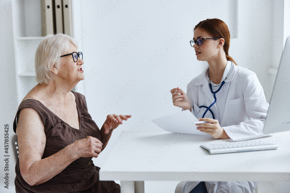 elderly woman patient examination by a doctor medical office elderly woman patient examination by a doctor medical office