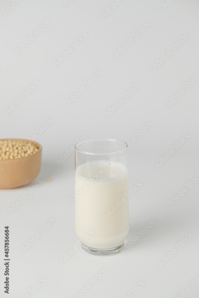 Soy vegetable milk in the glass and soybeans. Homemade. Isolated and white background Soy vegetable milk in the glass and soybeans. Homemade. Isolated and white background