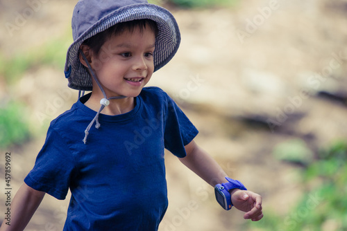 Cute mixed race little boy bushwalking on the Warrumbungles National Park Nature Trail photo