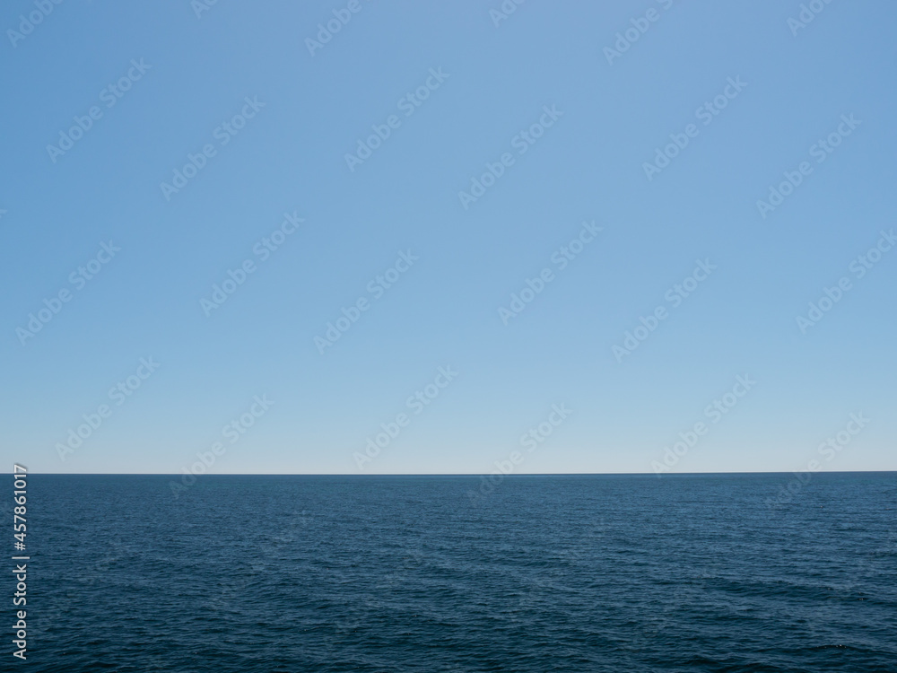 Deep blue ocean with pale blue sky Deep blue ocean with pale blue sky