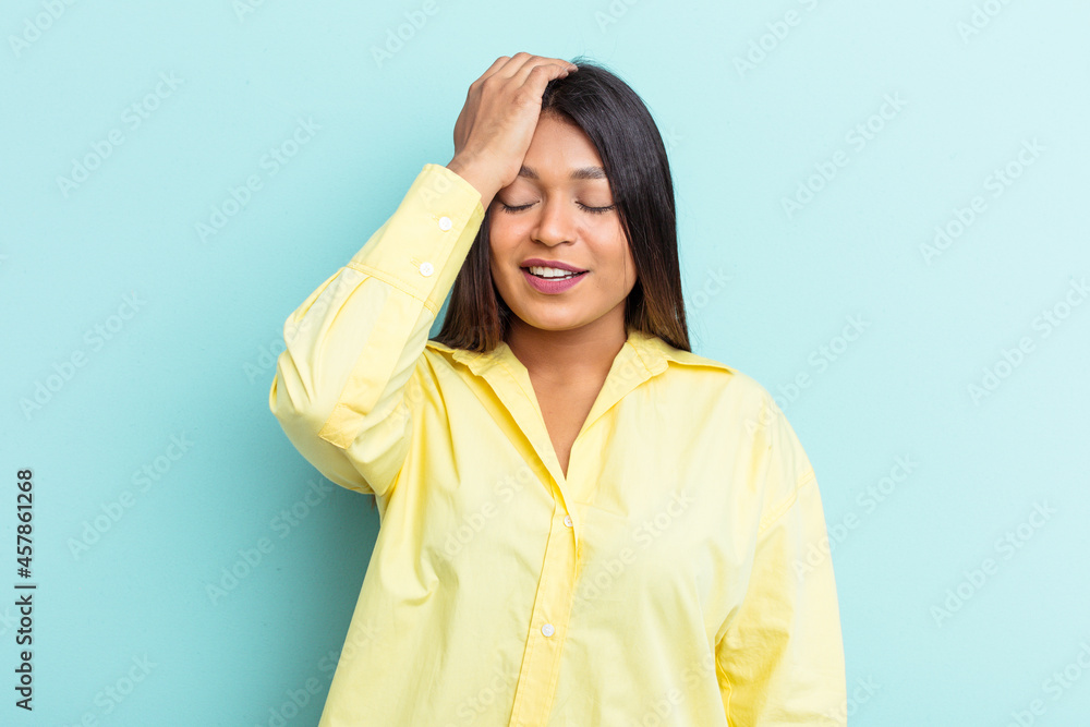 Young Venezuelan woman isolated on blue background tired and very sleepy keeping hand on head. Young Venezuelan woman isolated on blue background tired and very sleepy keeping hand on head.
