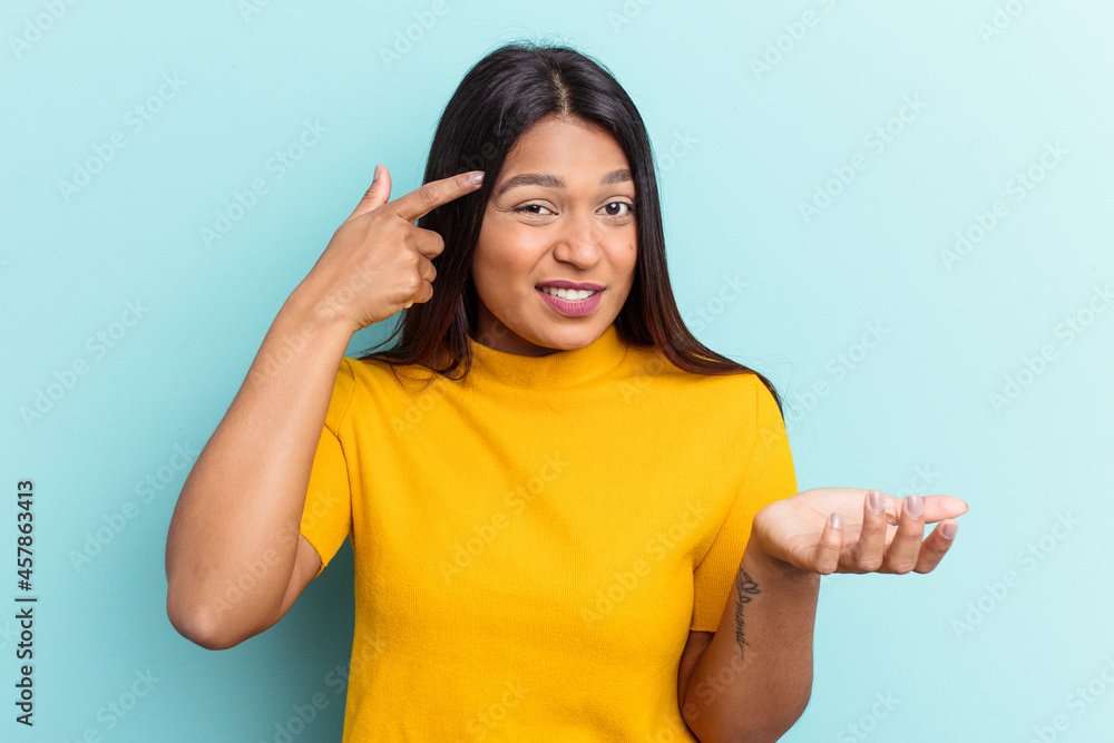 Young Venezuelan woman isolated on blue background showing a disappointment gesture with forefinger. Young Venezuelan woman isolated on blue background showing a disappointment gesture with forefinger.