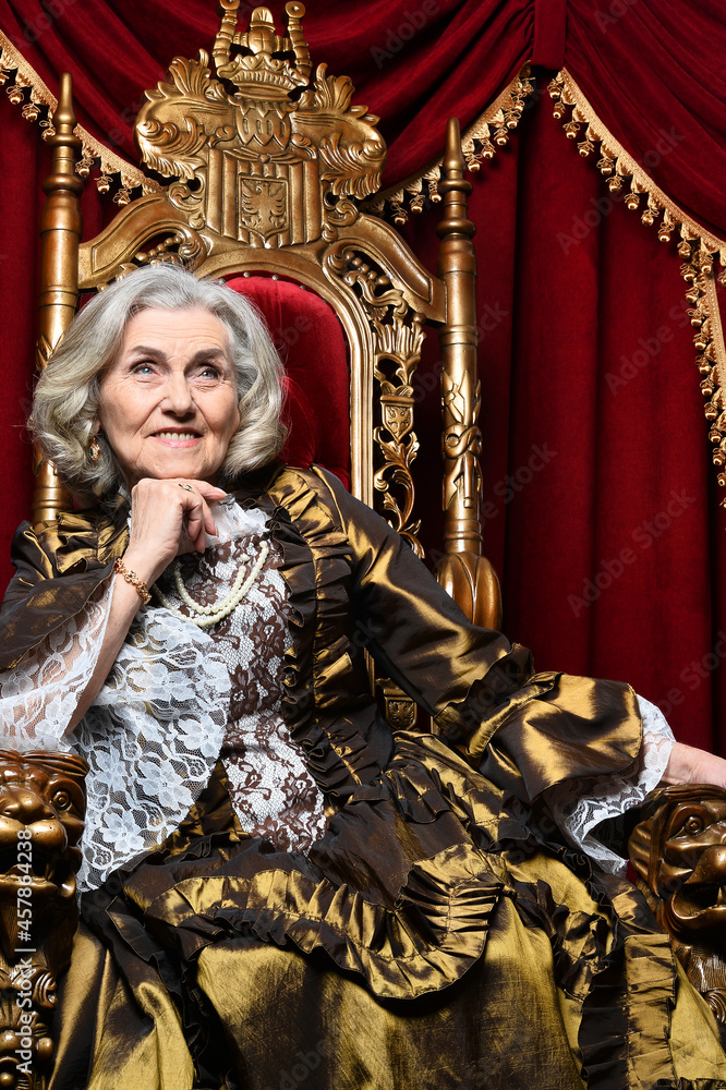 Fototapeta premium Portrait of a surprised beautiful senior queen on throne