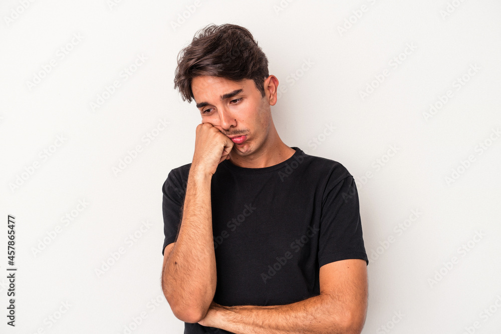 Young mixed race man isolated on white background who feels sad and pensive, looking at copy space. Young mixed race man isolated on white background who feels sad and pensive, looking at copy space.