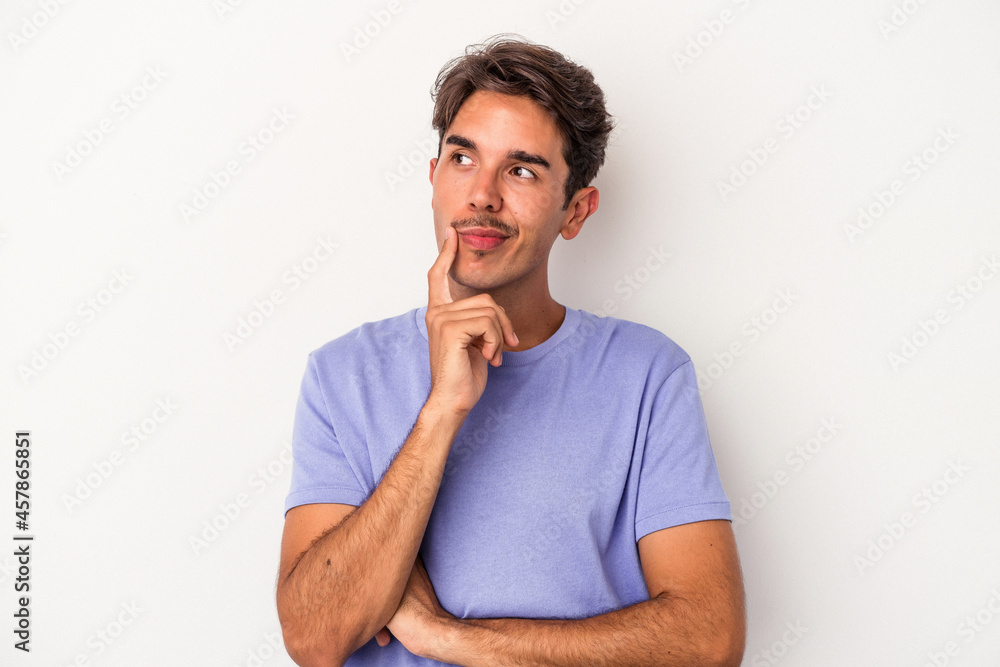Young mixed race man isolated on white background contemplating, planning a strategy, thinking about the way of a business. Young mixed race man isolated on white background contemplating, planning a strategy, thinking about the way of a business.