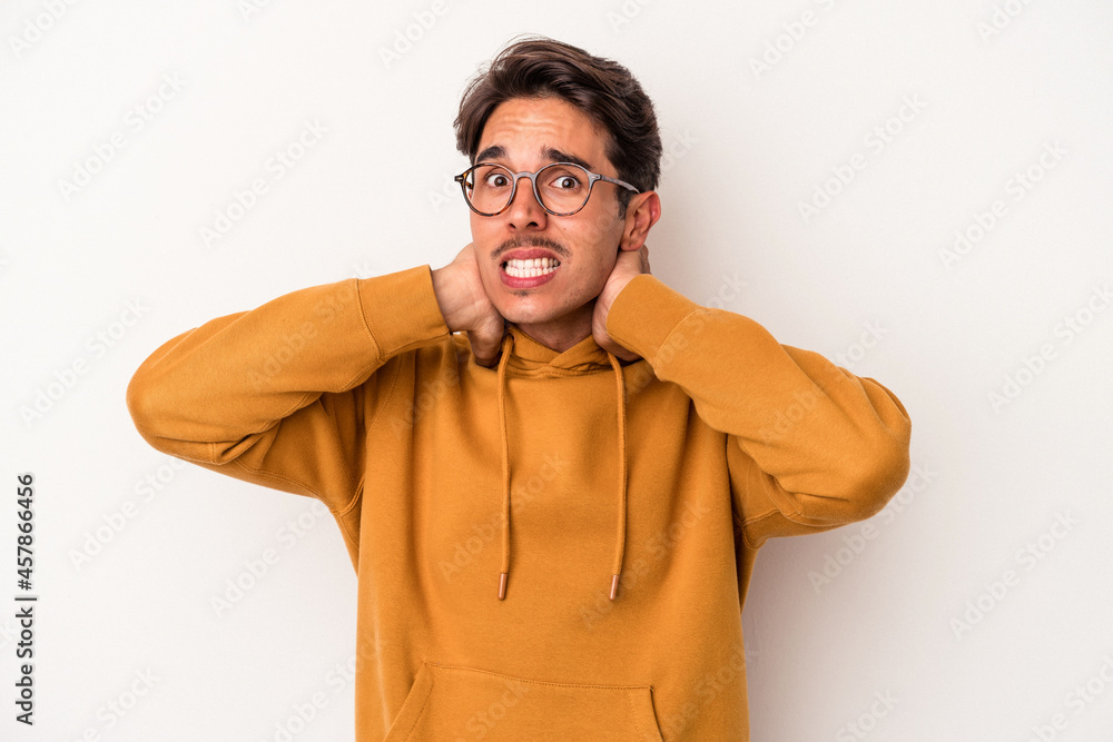 Young mixed race man isolated on white background touching back of head, thinking and making a choice. Young mixed race man isolated on white background touching back of head, thinking and making a choice.