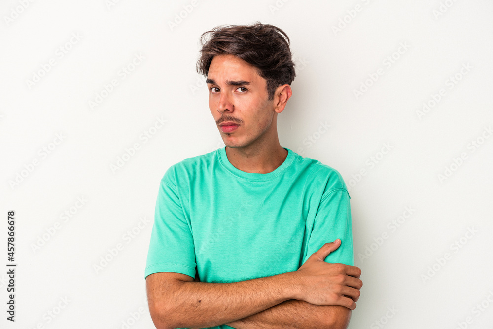 Young mixed race man isolated on white background unhappy looking in camera with sarcastic expression. Young mixed race man isolated on white background unhappy looking in camera with sarcastic expression.