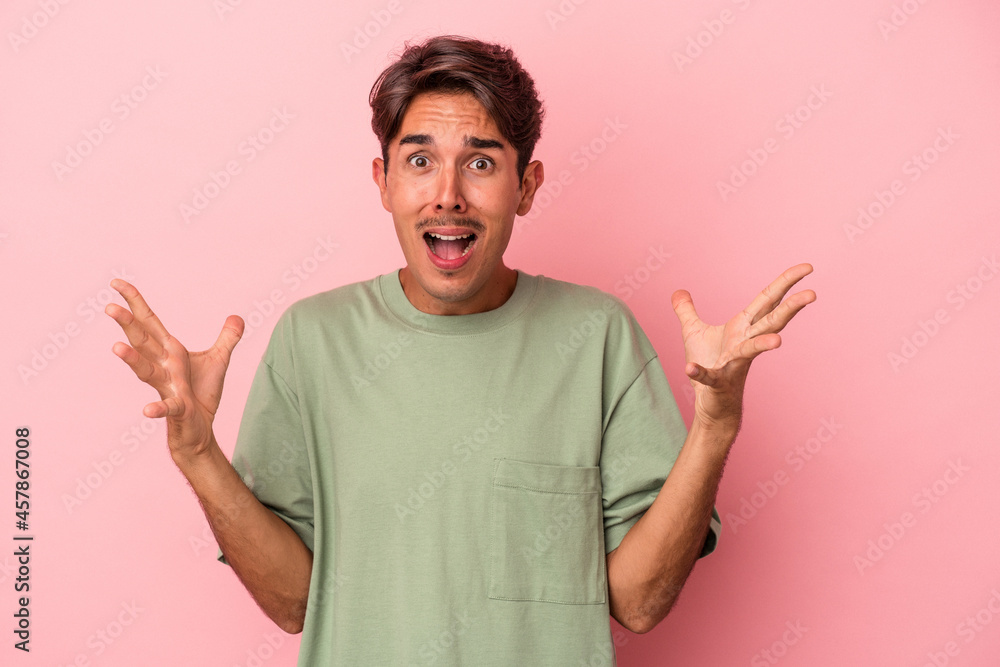 Young mixed race man isolated on white background screaming to the sky, looking up, frustrated. Young mixed race man isolated on white background screaming to the sky, looking up, frustrated.