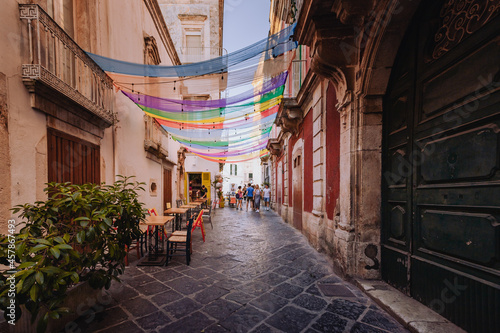 Alley in the historic center of Martina Franca with colored awnings