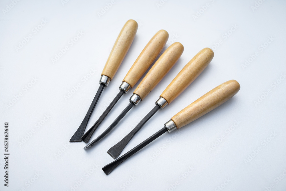 Small chisels for cutting wood on white isolate. Wooden handles. Small chisels for cutting wood on white isolate. Wooden handles.