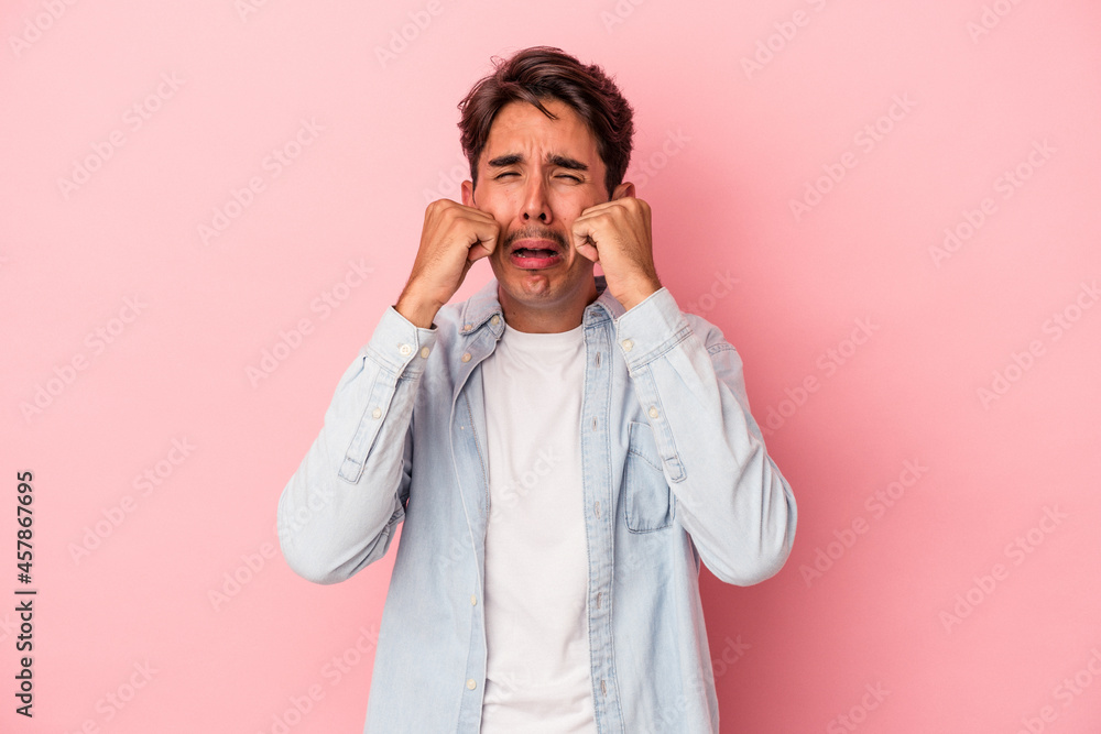 Young mixed race man isolated on white background whining and crying disconsolately. Young mixed race man isolated on white background whining and crying disconsolately.