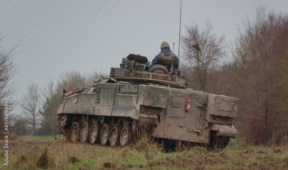 Fototapeta premium British army Warrior FV510 light infantry fighting vehicle tank in action on a military exercise, Salisbury Plain, Wiltshire UK