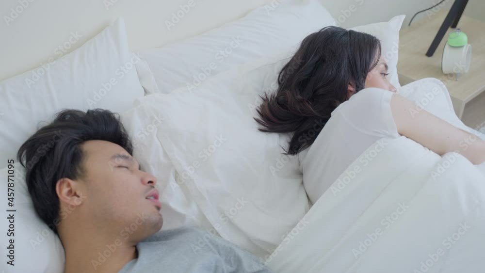 Asian woman feel frustrated from husband have bad breath after wake up Asian woman feel frustrated from husband have bad breath after wake up