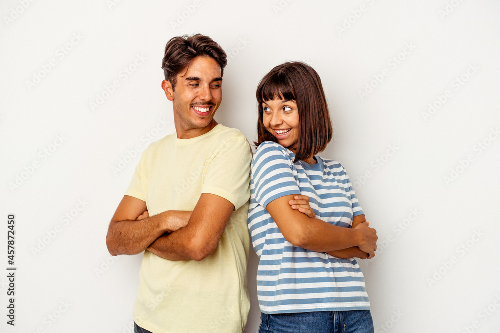 Young mixed race couple isolated on white background laughing and having fun. Young mixed race couple isolated on white background laughing and having fun.