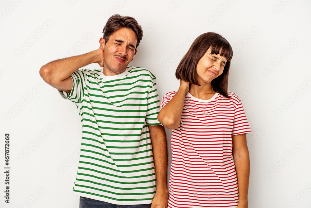 Young mixed race couple isolated on white background having a neck pain due to stress, massaging and touching it with hand. Young mixed race couple isolated on white background having a neck pain due to stress, massaging and touching it with hand.
