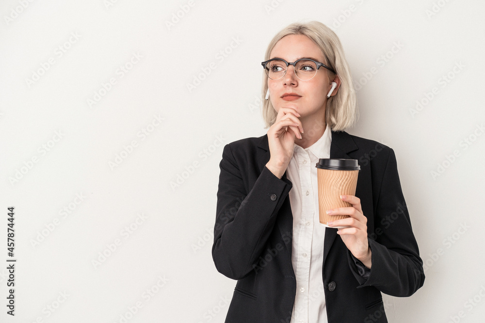 Young caucasian business woman holding take away coffee isolated on white background looking sideways with doubtful and skeptical expression.