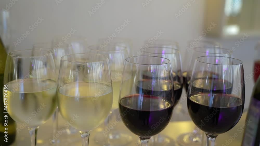 Glasses with white and red wine in restaurant. Party, welcome alcoholic drinks. Glasses with white and red wine in restaurant. Party, welcome alcoholic drinks.